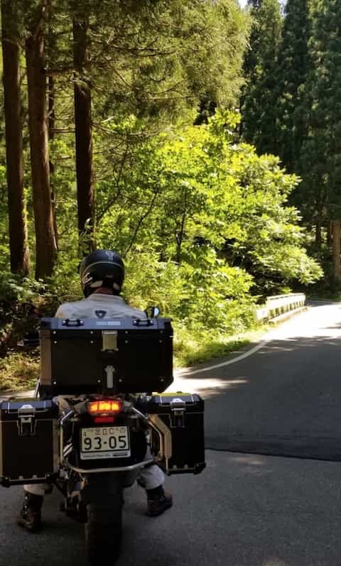 Ninjatours Japan motorcycle tour Hachimantai forest ride shady road on BMW RS1200